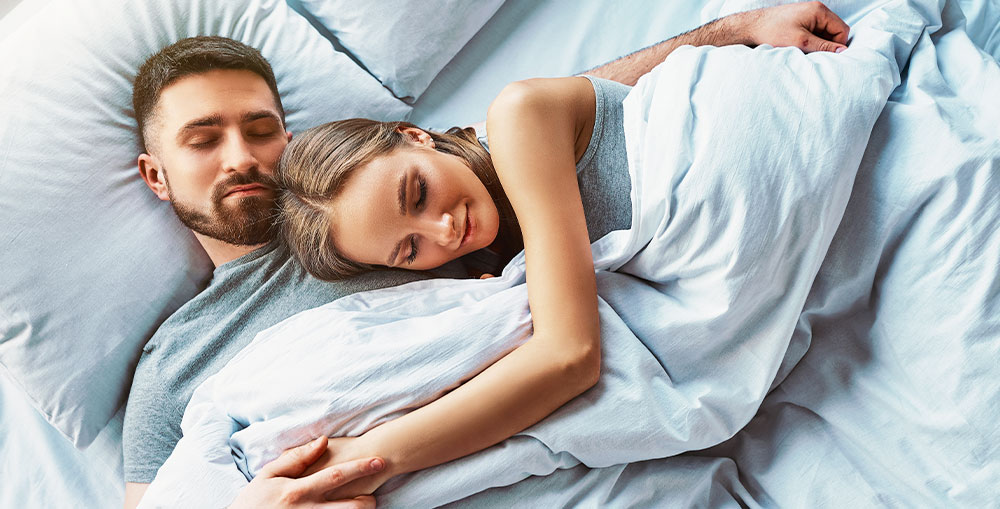 Happy couple enjoying a comfortable sleep under a tailored tog THREE Duvets, providing optimal warmth and comfort.