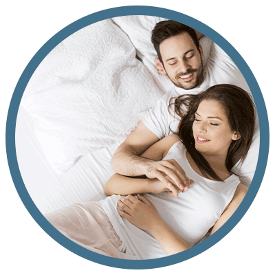 Couple on bed adorned with a THREE Duvets alpaca duvet section, showcasing the luxurious comfort