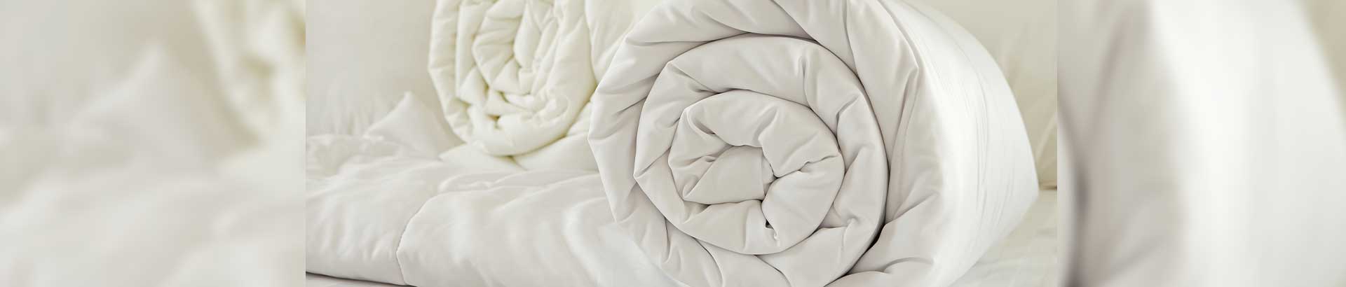 Silk duvets vs a synthetic duvet to show the natural properties on THREE duvets