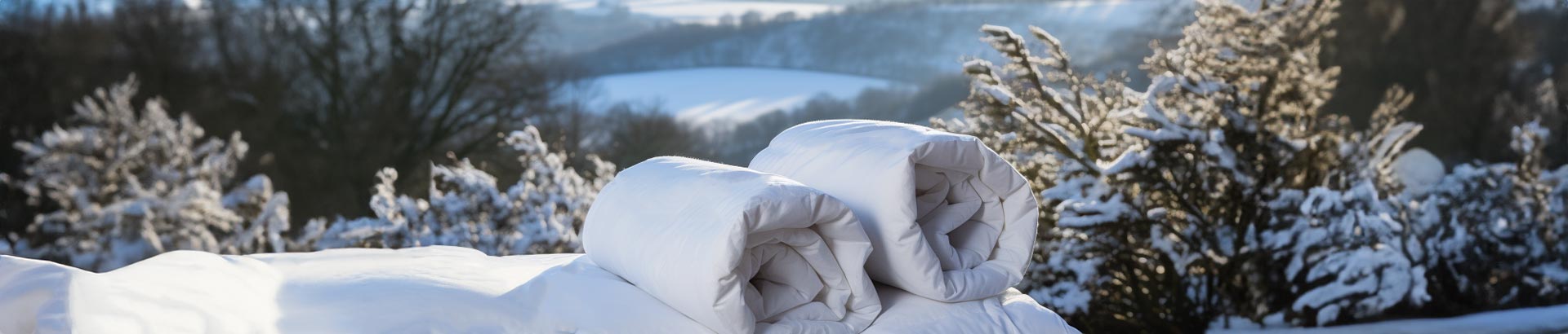 Winter duvet options displayed amidst a snowy English country landscape, featuring the unique temperature-regulating THREE Duvets sections.