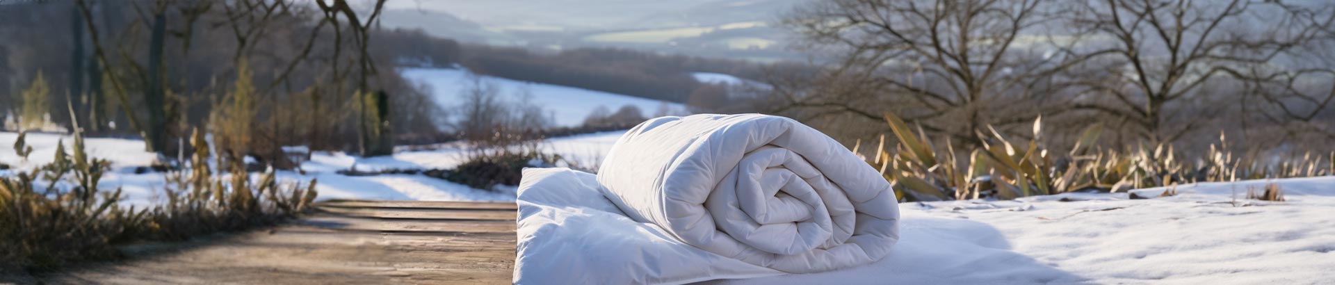 THREE Duvets British Wool Lightweight Section perfectly placed on a vintage swing in a lush garden, ideal for 'hot' sleepers enjoying the outdoors.