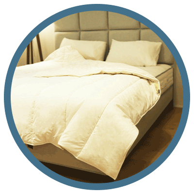 Cosy and comfortable bed adorned with a THREE Duvets British Wool duvet, showcasing natural warmth and comfort.